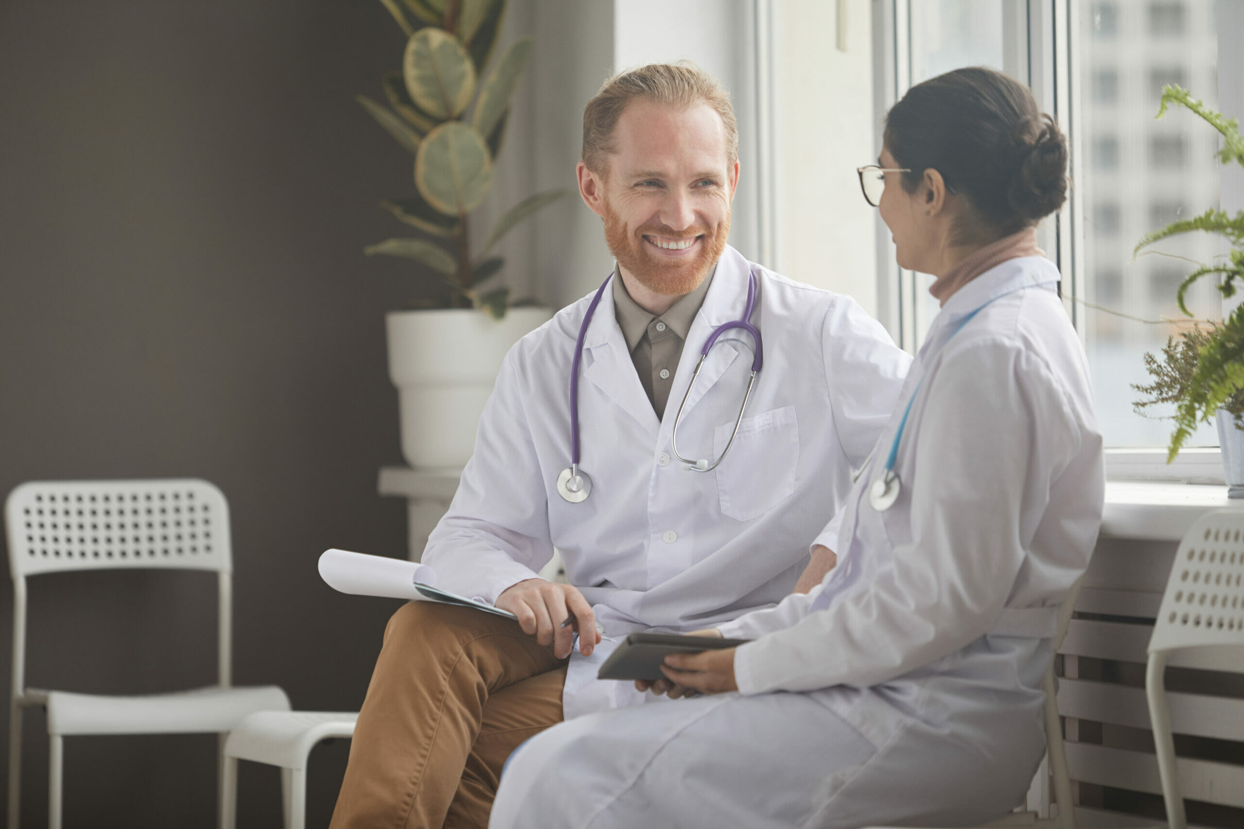 Doctor and nurse sitting at the corridor