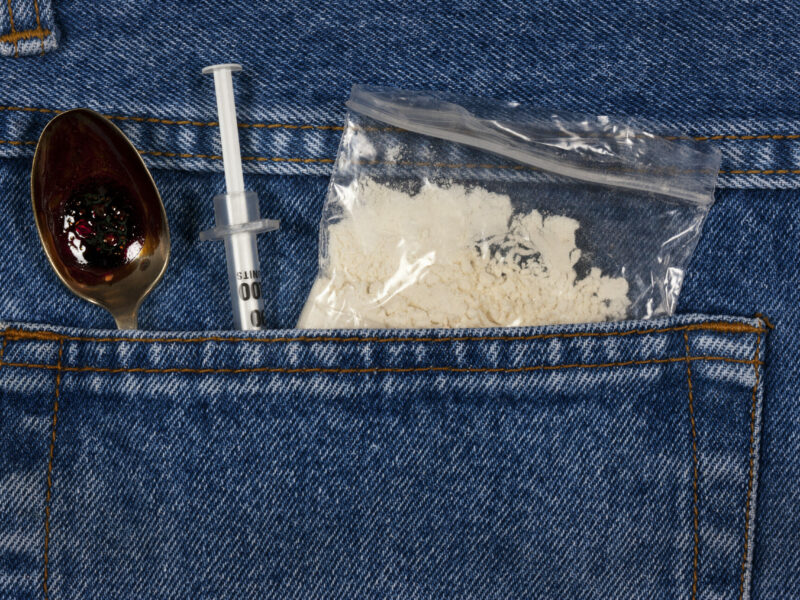 cocaine, spoon, and needle in jeans pocket