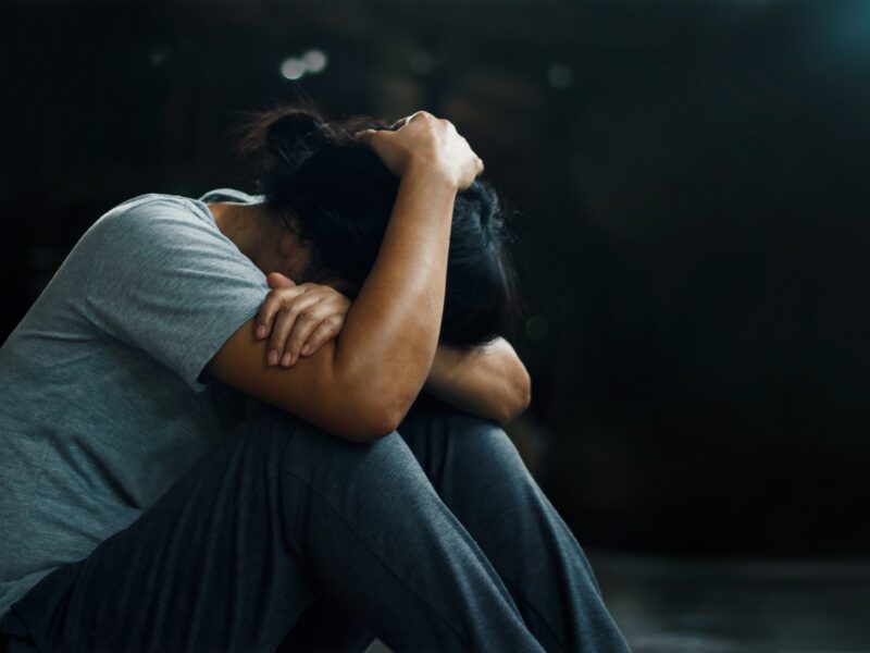 Person holding hands over head in despair